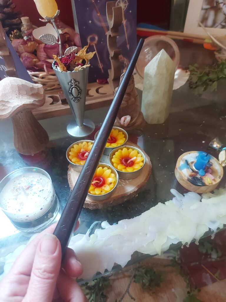 Guided by Gaia Tarot altar with candles, spell workings, crystals and a wand.