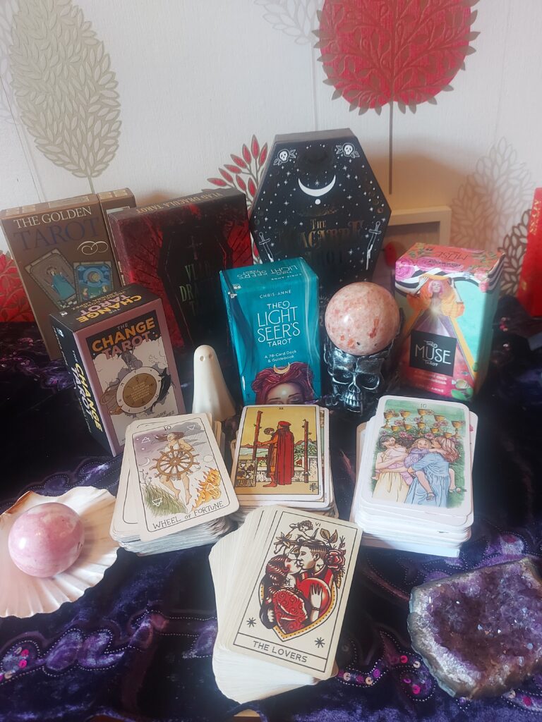 tarot card meanings, selection of tarot cards and crystals on tarot table